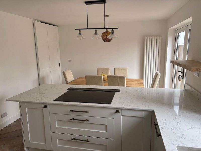 Modern white kitchen renovation with quartz worktops and contemporary finishes